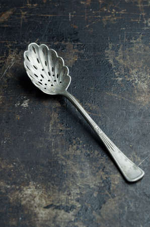 Close up of a teaspoon over dark grunge backgroundの写真素材