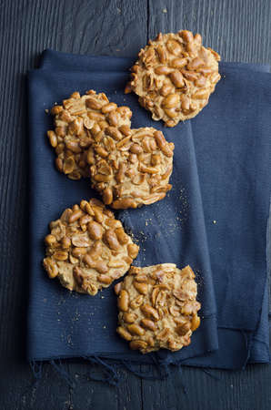 Homemade cookies with peanuts over black wooden table, above viewの写真素材