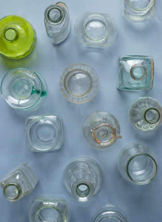 Multiple types of bottles and jars over blue background, top viewの写真素材
