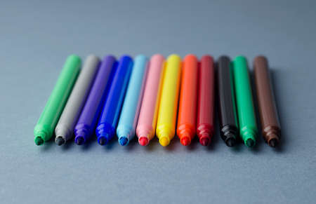 Multiple colorful magic markers over blue background, shallow depth of fieldの写真素材