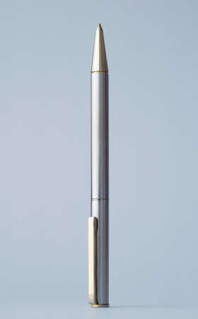 Single silver metallic pen over blue backgroundの写真素材