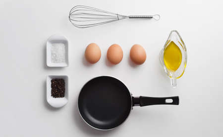 Scrambled eggs ingredients over white table, above viewの写真素材