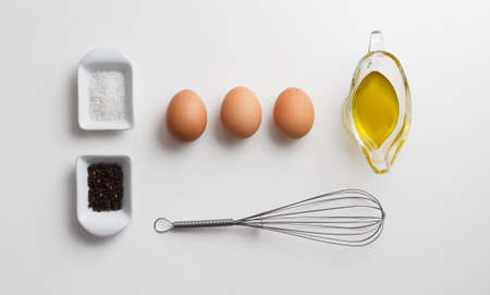 Scrambled eggs ingredients over white table, above viewの写真素材