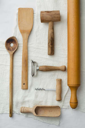 Collection of kitchen utensils well organized over white cloth, above viewの写真素材