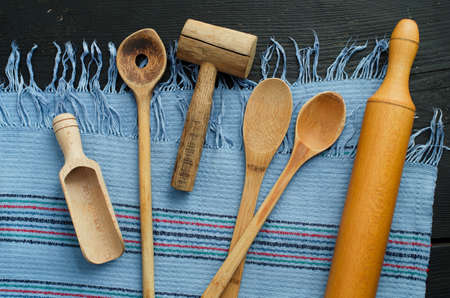 Kitchen wooden utensils over blue rustic cloth, horizontal and above view.の写真素材