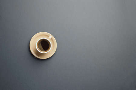 Cup of dark coffee over dark gray background with copy space for text or other designの写真素材