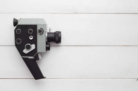 Vintage video camera over white wooden table, above view and with copy space for text or other desingの写真素材