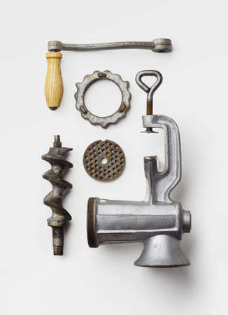 Metal meat grinder well arranged over white background, above viewの写真素材