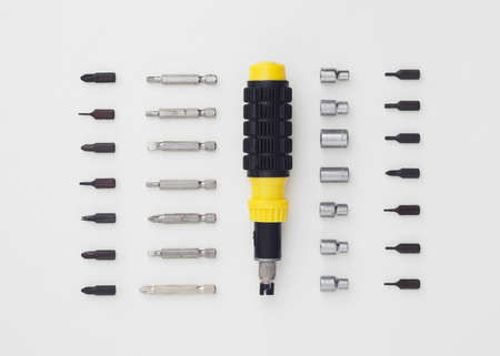 Ratchet screwdriver well arranged over white background, above view