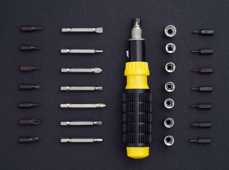 Ratchet screwdriver well arranged over black background, above viewの写真素材