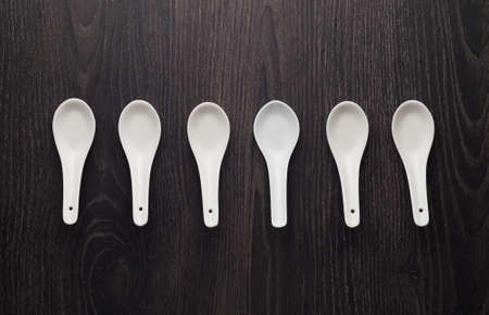 Collection chinese soup spoons over dark wooden tableの写真素材