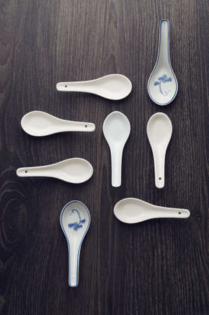 Collection chinese soup spoons over dark wooden tableの写真素材