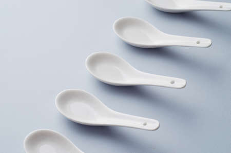 Collection of chinese soup spoons over blue backgroundの写真素材