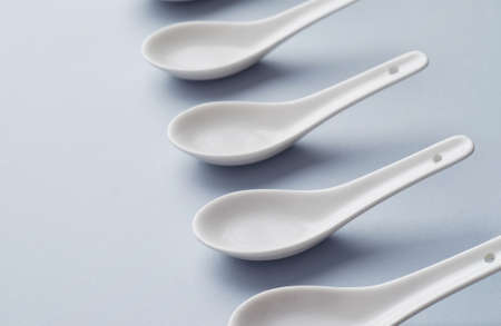 Collection of chinese soup spoons over blue backgroundの写真素材