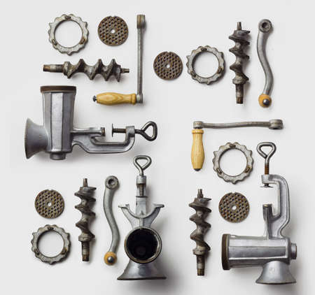 Collection of metal meat grinders well arranged over white background, above viewの写真素材