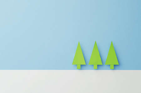 Small Paper Christmas Trees cut from green paper over blue backgroundの写真素材