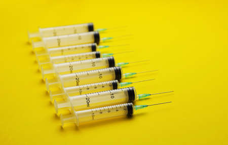 Details of syringes over bright yellow backgroundの写真素材