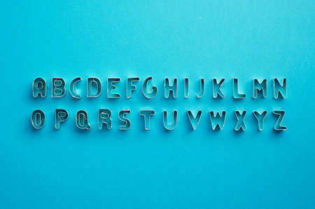 Alphabet letters organized over blue background, top viewの写真素材