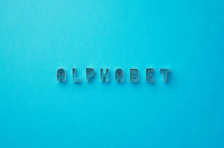 Alphabet word written with cookie cutters molds over blue background, top viewの写真素材