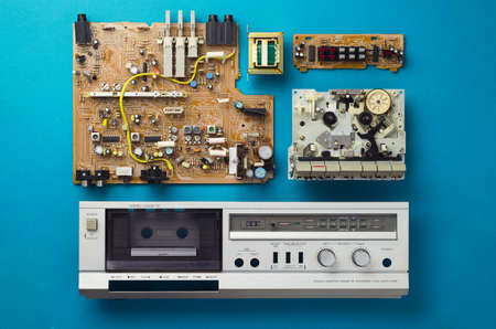 Vintage stereo cassette deck components well organized over blue background, top viewの写真素材
