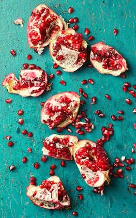 Pomegranates over grunge green wooden background, above viewの写真素材