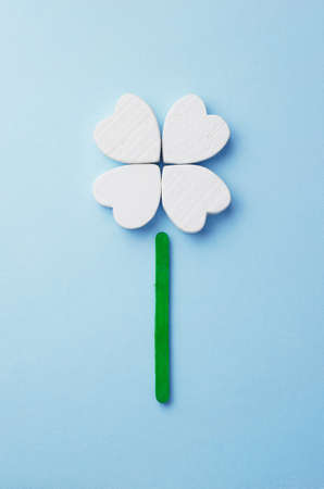 Hearts arranged as clover over blue background, top viewの写真素材