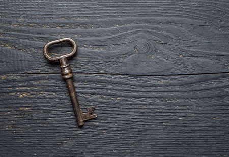 Vintage Key over dark wooden table, top view with negative spaceの写真素材