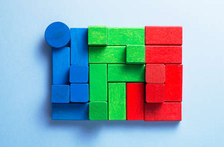Colorful wooden cubes organized over blue background, top viewの写真素材