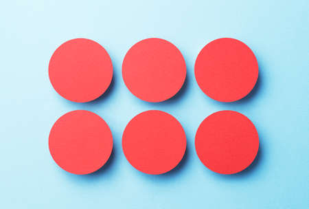 Paper circles organized over blue background, top viewの写真素材