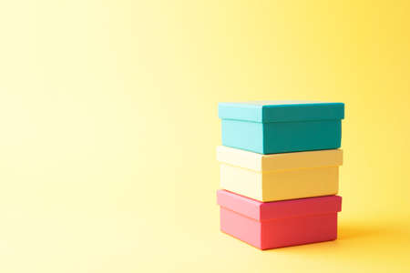 Stack of gift boxes over yellow backgroundの写真素材