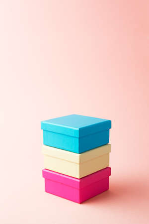 Stack of gift boxes over pink background