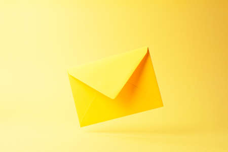Yellow envelope dropped over yellow background