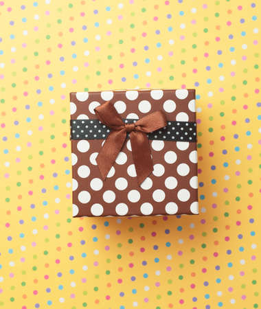 Gift box over a colorful backgroundの写真素材