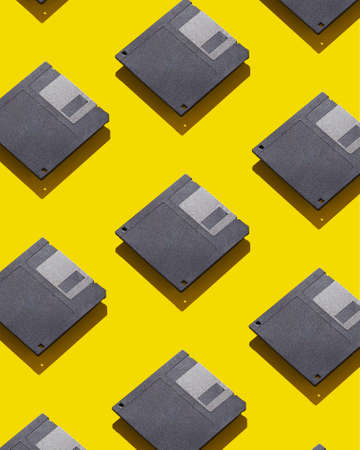 Floppy disks organized over yellow backgroundの写真素材