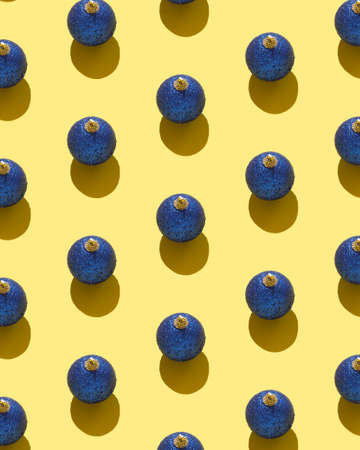 Christmas baubles organized over yellow background