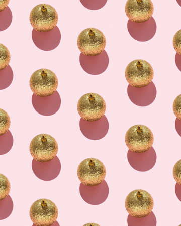 Christmas baubles organized over pink background