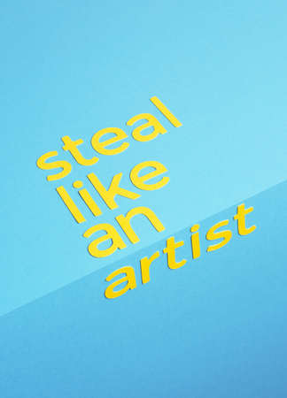 Steal like an artist quote made of paper over blue backgroundの写真素材