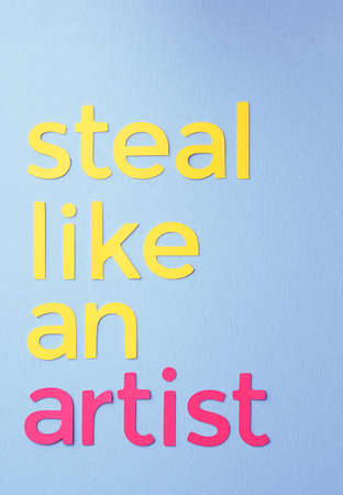Steal like an artist quote made of paper over blue backgroundの写真素材