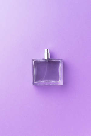 Perfume bottle over purple backgroundの写真素材