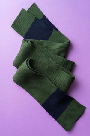 Knit winter scarf over purple backgroundの写真素材