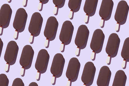 Ice cream organized in a row over purple backgroundの写真素材