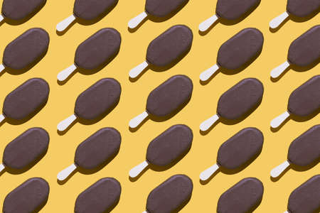 Ice cream organized in a row over yellow background