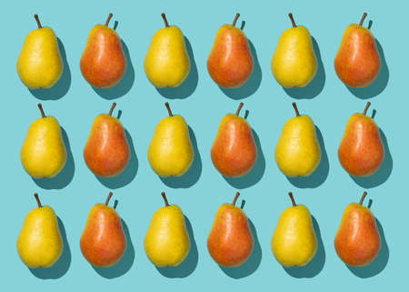 Multiple pears organized in a row over blue background