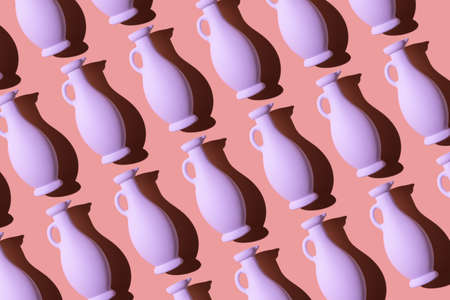 Colorful painted glass bottles organized in a row over coral backgroundの写真素材