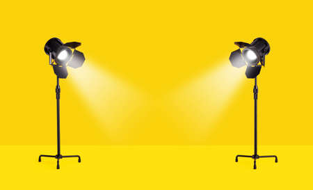 Studio lamps over yellow backgroundの写真素材