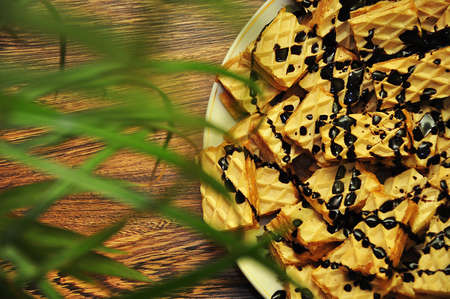 Plate with tasty, chocolate waffers, parial view,