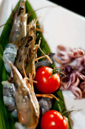 Greiiled shrimps with octupus and tomatos, isolatedの写真素材