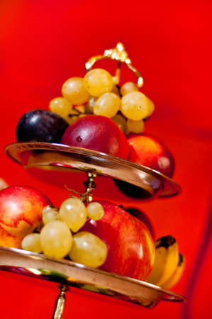 Pyramid made with fruits on red backgroundの写真素材