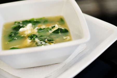 Straciatella soup in white bowlの写真素材