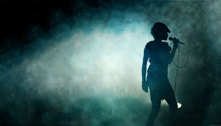Singing woman silhouette with smoke backgroundの写真素材